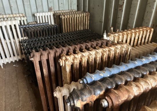 Assorted cast iron radiators in varying conditions awaiting restoration at Blast Spray Polish